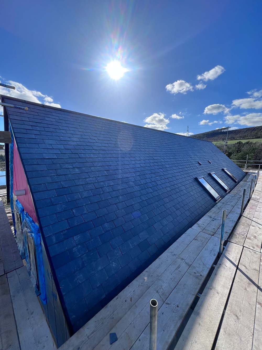 IMG-20251015-WA0035 Modern pitched roof with the sun in the background