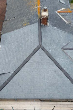 Birds eye view of new roof and old roof on a coastal property